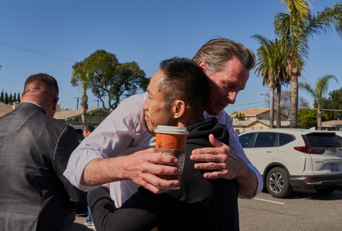 California Governor Gavin Newsom hugs Thinh Luong, 46, a school teacher, near the Star Dance Studio in Monterey Park, California on January 23, 2023.  (Philip Cheung for The Washington Post via Getty Images)
