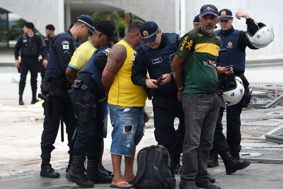 Security forces arrest supporters of Brazilian former President Jair Bolsonaro after retaking control of Planalto Presidential Palace in Brasília on Jan. 8, 2023. (TON MOLINA/AFP via Getty Images)