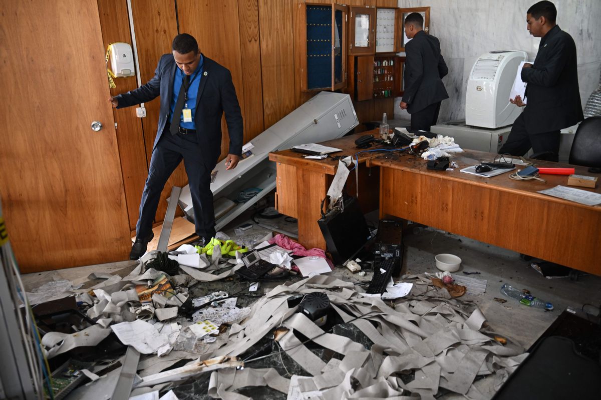 Planalto Presidential Palace security members inspect offices destroyed by supporters of former Brazilian President Jair Bolsonaro after an invasion in Brasilia on Jan. 9, 2023. (CARL DE SOUZA/AFP via Getty Images)