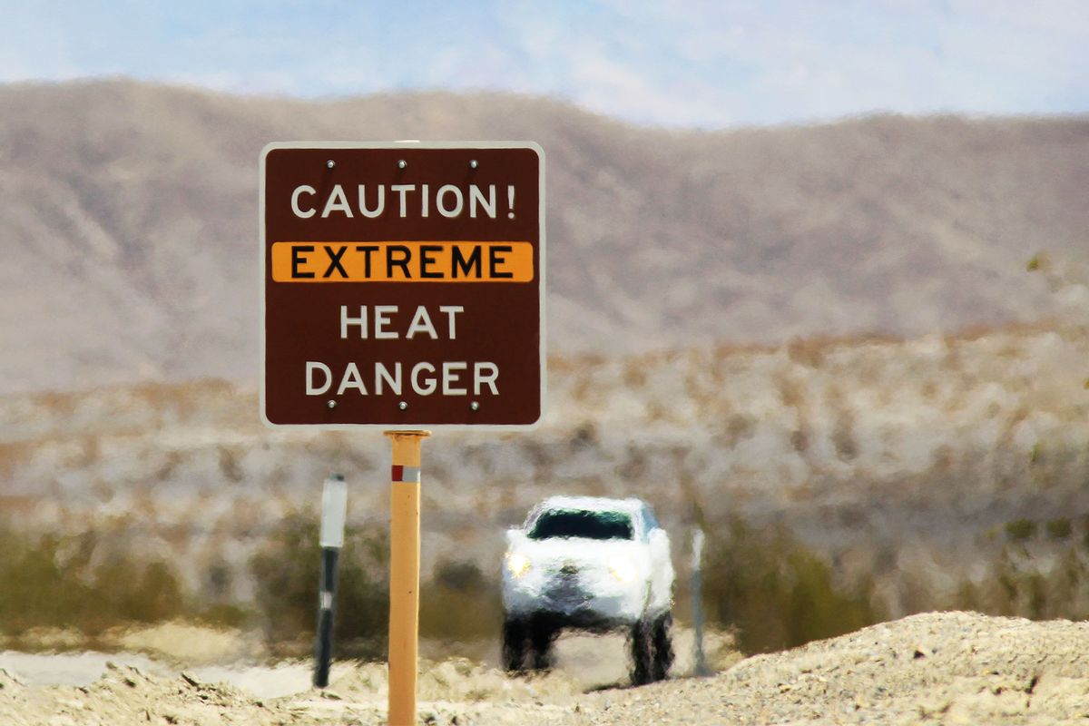 Heat waves rise near a heat danger warning sign on the eve of the AdventurCORPS Badwater 135 ultra-marathon race on July 14, 2013 in Death Valley National Park, California. (David McNew/Getty Images)
