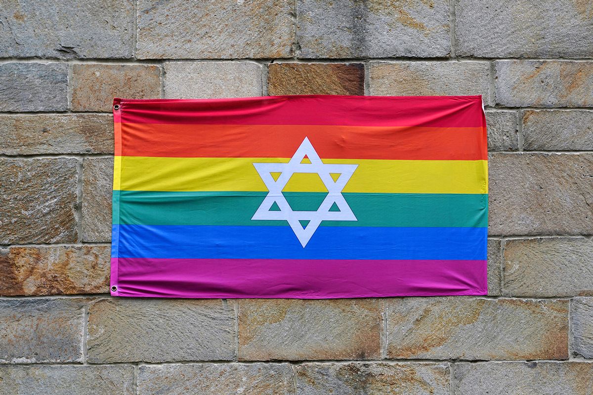 Gay pride rainbow flag with Star of David, pinned to a stone wall (Getty Images/peterspiro)