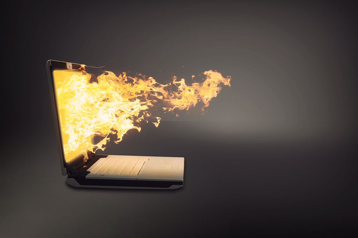 Laptop on fire (Getty Images/ALLVISIONN)