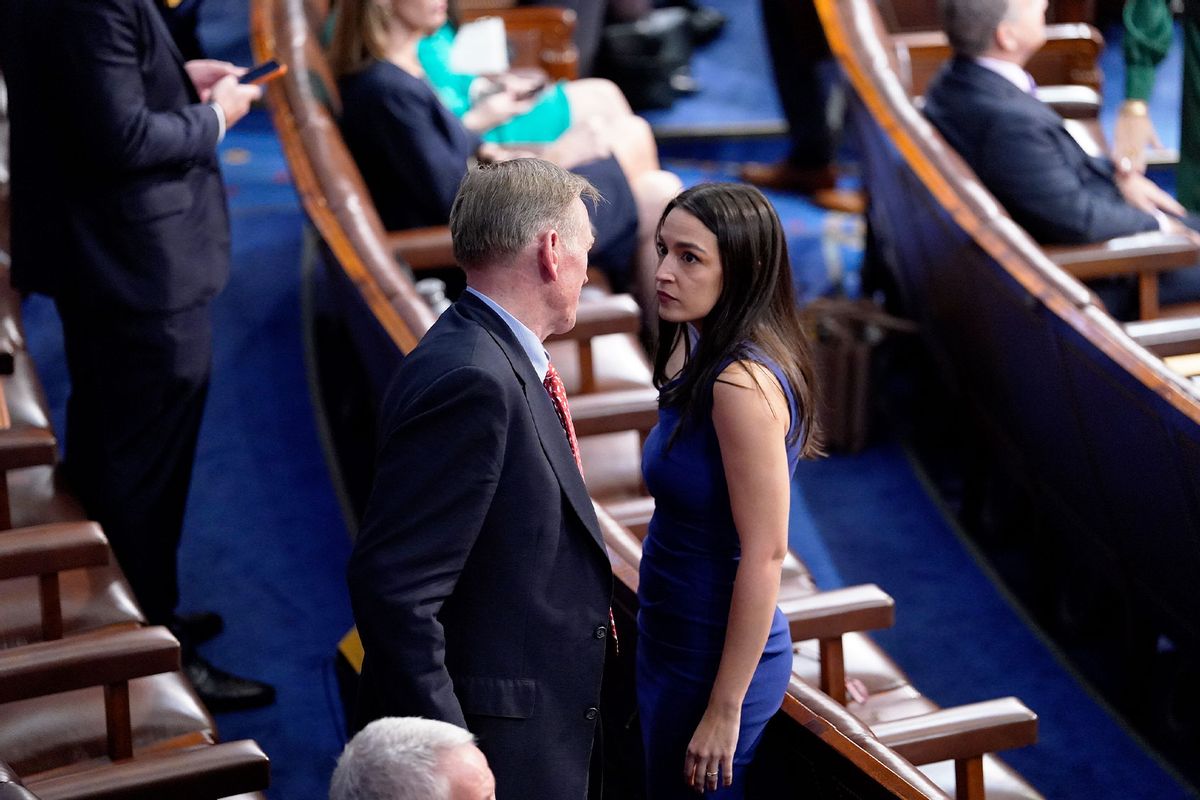 Rep. Paul Gosar (R-Ariz.) talks with Rep. Alexandria Ocasio-Cortez (D-N.Y.) on the opening day of the 118th Congress on Tuesday, January 3, 2023, in Washington DC. (Jabin Botsford/The Washington Post via Getty Images)