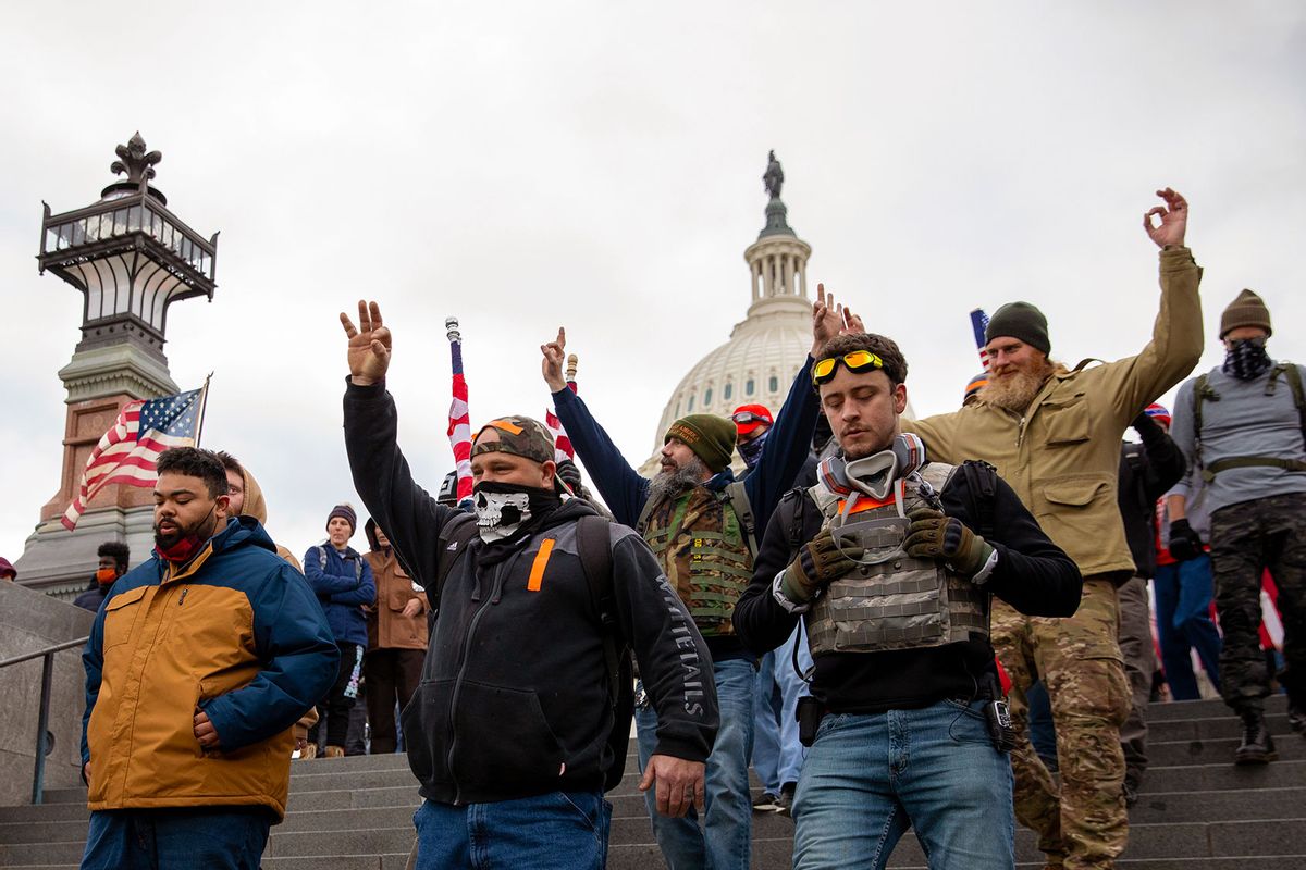 Members of the Proud Boys make a hand gesture while walking near the US Capitol in Washington, DC on Wednesday, January 6, 2021. (Amanda Andrade-Rhoades/For The Washington Post via Getty Images)