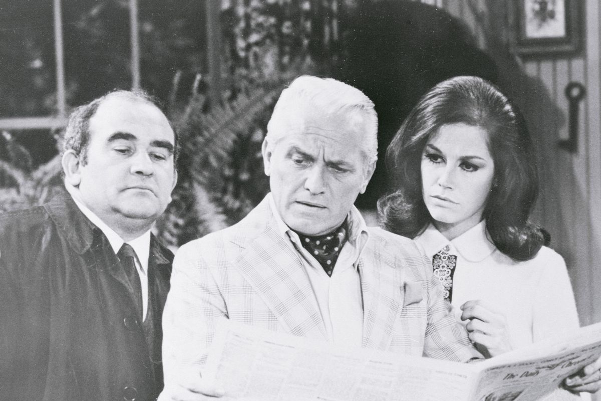 Newsroom boss Lou Grant (Edward Asner, left), newscaster Ted Baxter (Ted Knight) and Mary Richards (Mary Tyler Moore) anxiously peruse a newspaper review of a little theatre play in which they appear, on The Mary Tyler Moore Show. (Getty Images/CBS Television Network/Bettmann Contribuutor)
