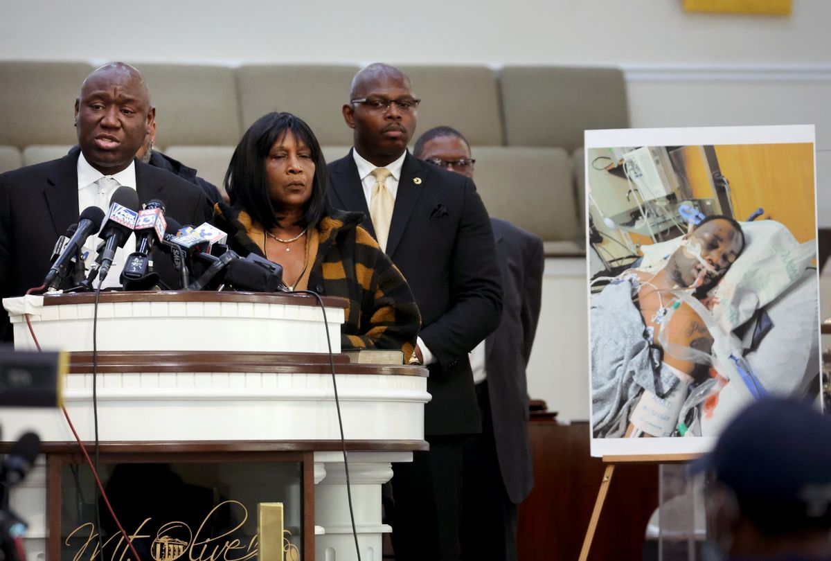 Flanked by Rodney Wells (C) and RowVaughn Wells, the stepfather and mother of Tyre Nichols, civil rights attorney Ben Crump speaks next to a photo of Nichols during a press conference on January 27, 2023 in Memphis, Tennessee. (Scott Olson/Getty Images)