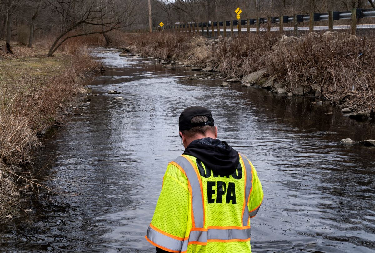 Ron Fodo, Ohio EPA Emergency Response, looks for signs of fish and also agitates the water in Leslie Run creek to check for chemicals that have settled at the bottom following a train derailment that is causing environmental concerns on February 20, 2023 in East Palestine, Ohio.  (Michael Swensen/Getty Images)