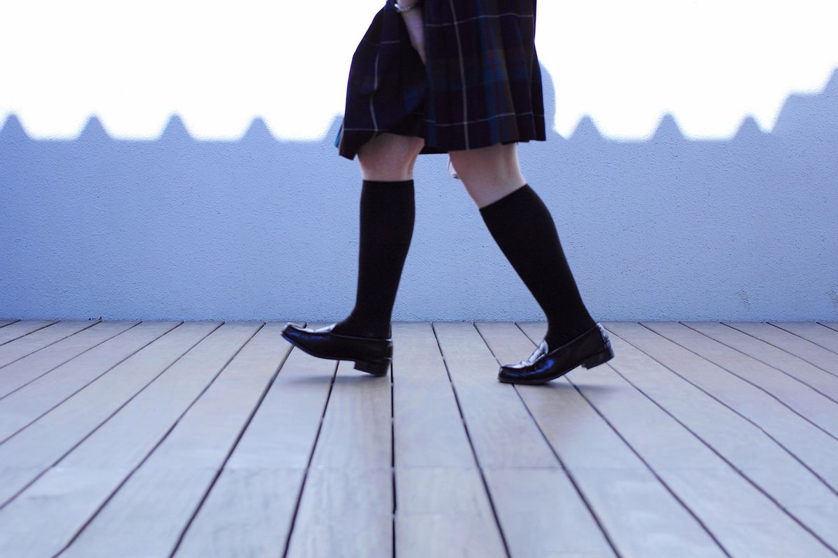 Low Section Of Schoolgirl Walking On Footpath (Getty Images / kyoko kiyama / EyeEm)