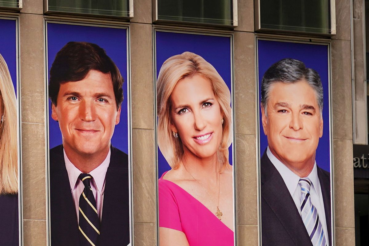 Advertisements featuring Fox News personalities, including Tucker Carlson, Laura Ingraham and Sean Hannity, adorn the front of the network's headquarters building in New York. (Drew Angerer/Getty Images)