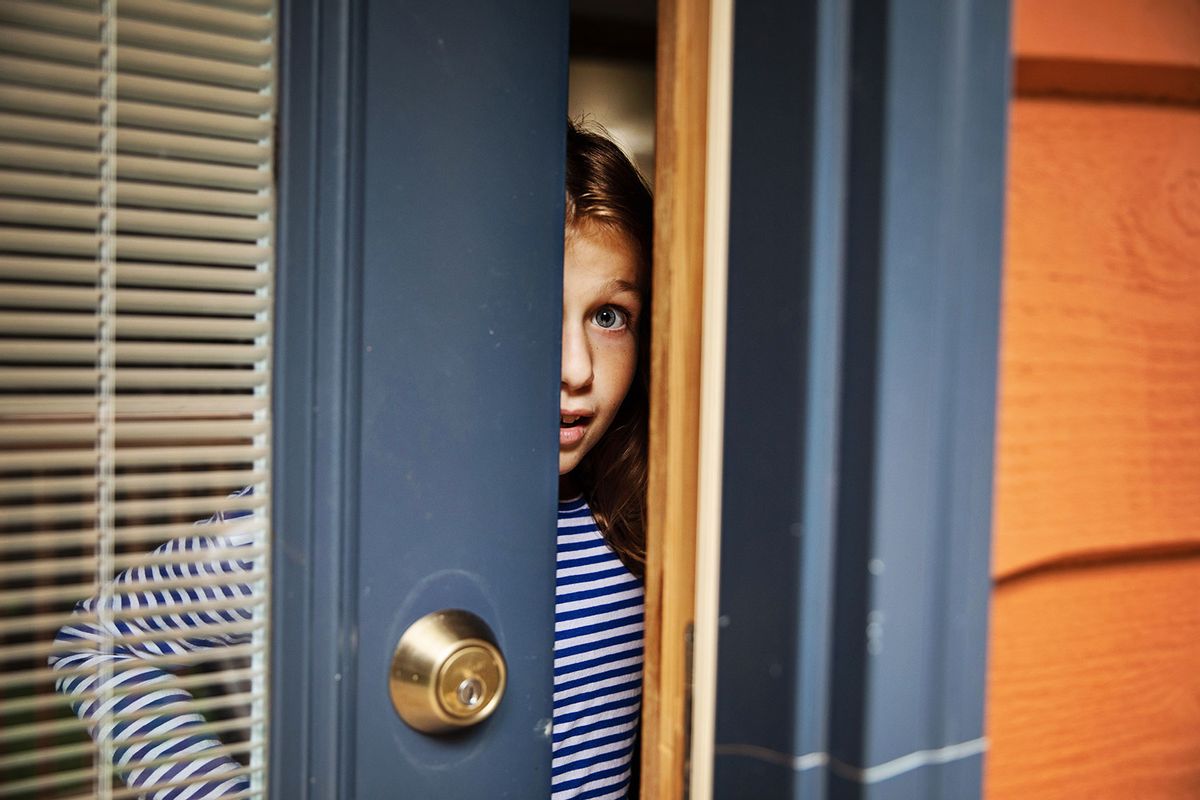 Young girl opening front door (Getty Images/vitapix)