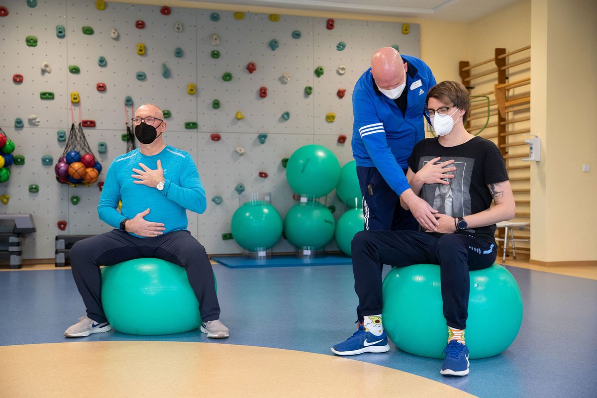 Long-covid patients do breathing training with a physiotherapist in a gymnastics room at the Teutoburger Wald Clinic, a rehabilitation clinic for post-covid patients.  (Friso Gentsch/picture alliance via Getty Images)