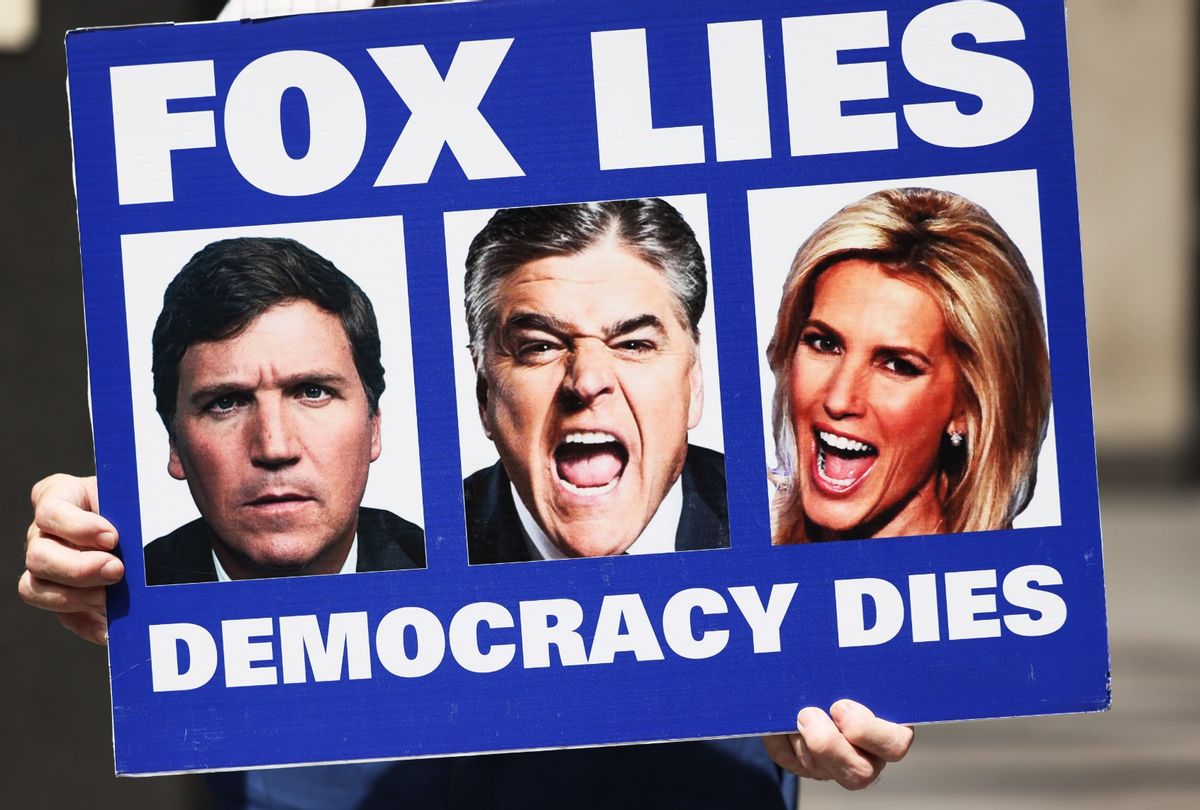 A person holds up as sign in a "Fox can't handle the truth" protest outside Fox News headquarters on June 14, 2022 in New York City.  (Michael M. Santiago/Getty Images)