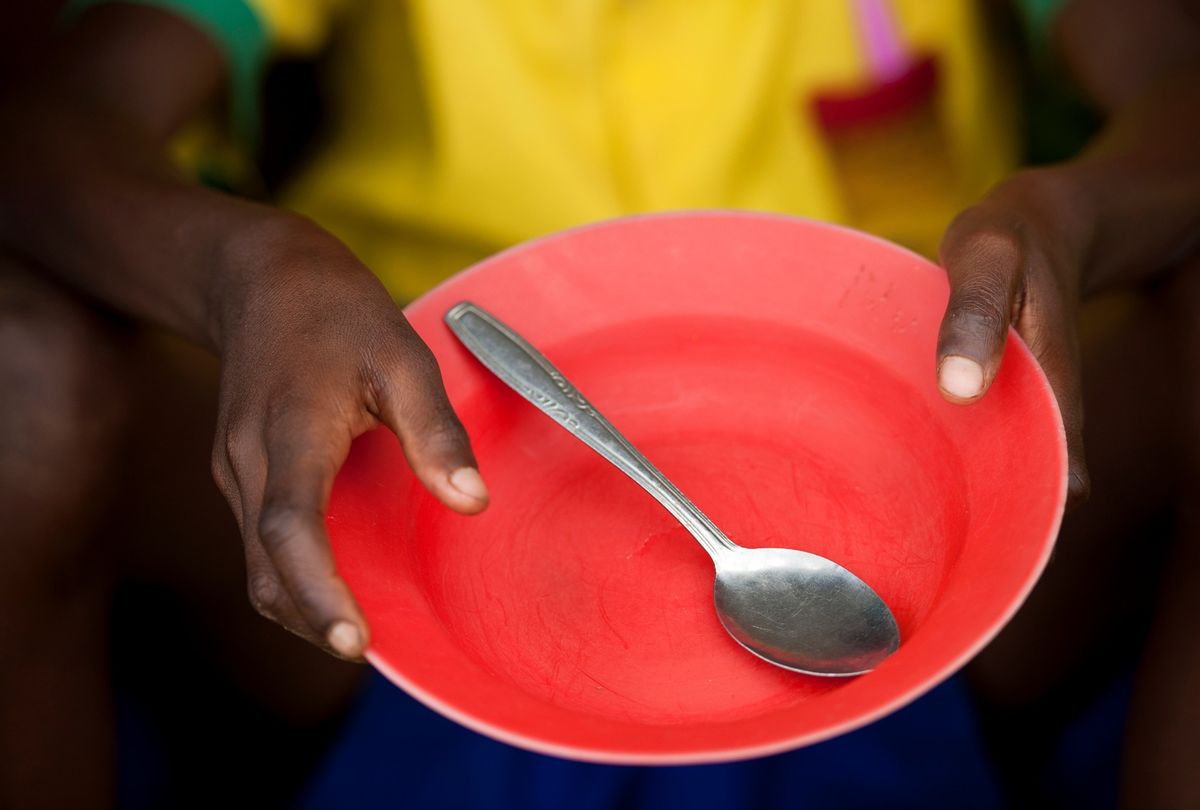 Child holds empty plate. (Getty Images/Claudiad)