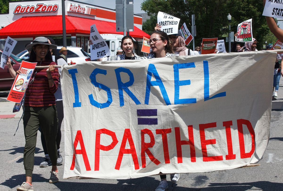 Free Palestine advocates hold a banner that equates Israel with an apartheid state while marching in Columbus, Ohio to protest the Israeli occupation of Palestine. (Stephen Zenner/SOPA Images/LightRocket via Getty Images)