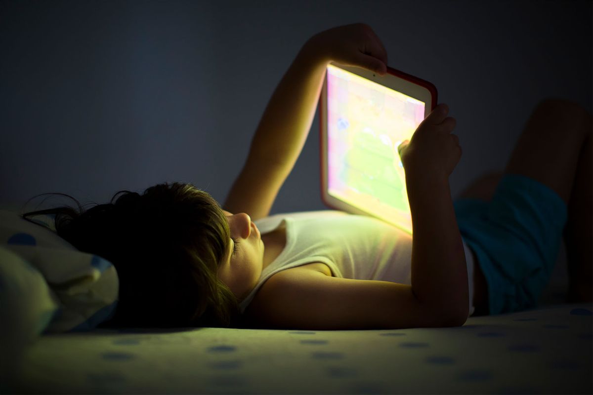 5 year old boy using a digital tablet in the dark (Getty Images/Thanasis Zovoilis)