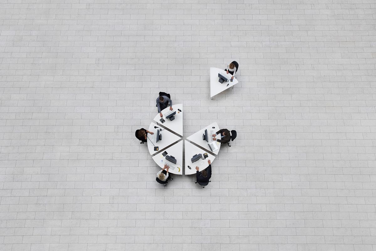 Office seen from above with employees sitting at their workstations in a formation shaped like a circle, one drawn away from her colleagues (Getty Images/Henrik Sorensen)