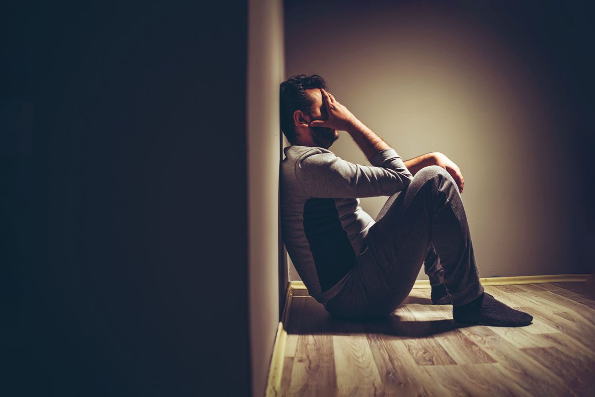 Young upset man sitting on floor (Getty Images/urbazon)