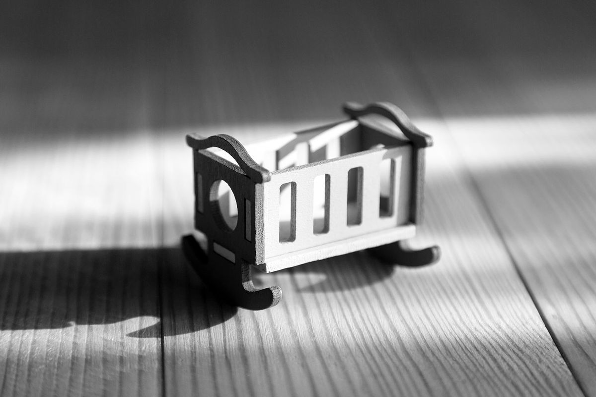 Empty wooden crib (Getty Images/Alexey Emelyanov)