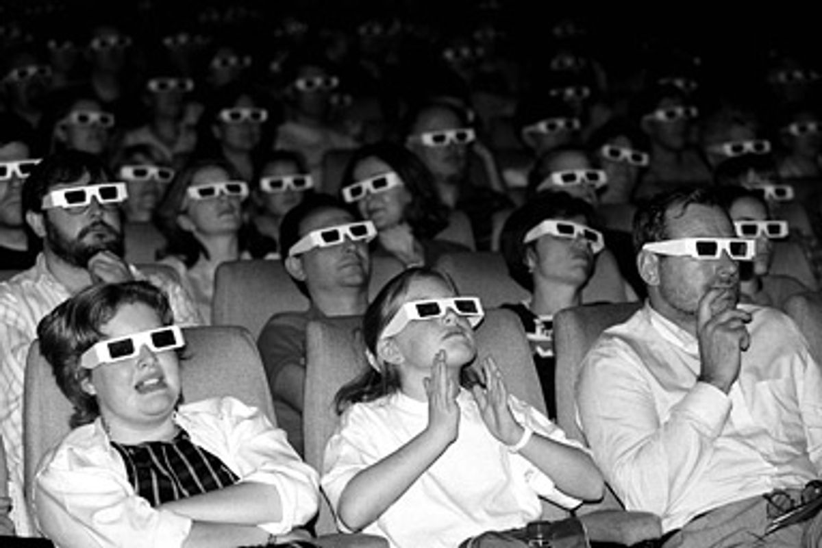 An audience watches a film through 3D glasses.  