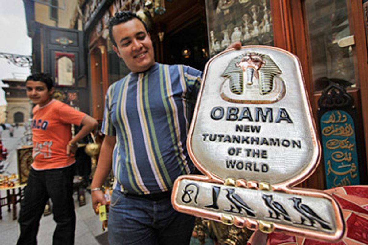 A souvenir shop-owner displays a recently-made metal plaque for sale to tourists reading "Obama, New Tutankhamun of the World", in the Khan el-Khalili market area of Cairo, Egypt Thursday, May 28, 2009, ahead of President Barack Obama's planned June 4 speech in Cairo on U.S. relations with the Muslim world. The sign refers to Tutankhamun who was one of the last Pharaohs of Egypt's 18th Dynasty and ruled during a crucial, turmoil-filled period in Egyptian history. Hieroglyphics at base of plaque were claimed by the vendor to spell the name "Obama".           
