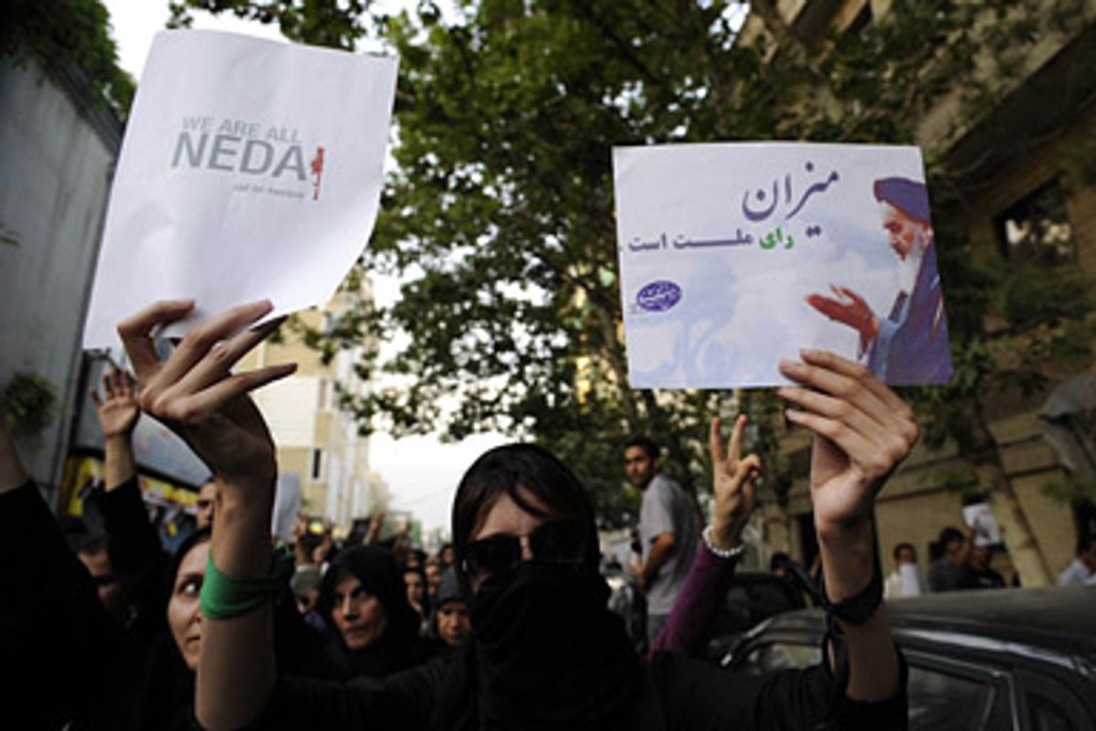 In this citizen photograph taken Sunday, June 28, 2009, a supporter of pro-reform leader Mir Hossein Mousavi, holds paper signs in Persian, reading " measure is people's vote", during a gathering at Ghoba Mosque in Tehran, Iran. Several thousand protesters who had gathered near north Tehran's Ghoba Mosque clashed with riot police in Tehran on Sunday in the country's first major post-election unrest in four days.