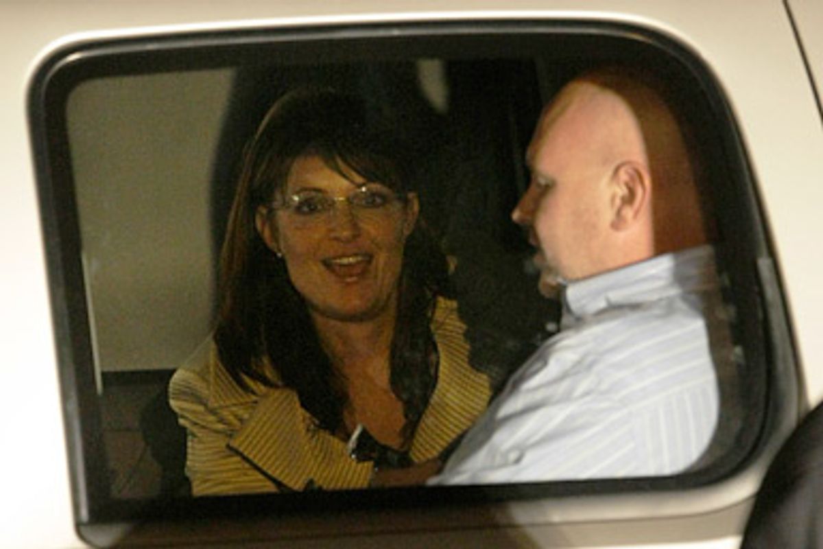 Republican vice presidential candidate Alaska Gov. Sarah Palin, sits in her vehicle with Steve Schmidt, chief strategist for the McCain campaign after arriving on a chartered plane with Cindy McCain, wife of  Republican presidential candidate Sen. John McCain, R-Ariz., for the Republican National Convention at the Minneapolis International Airport in Bloomington, Minn., Sunday, Aug. 31, 2008.