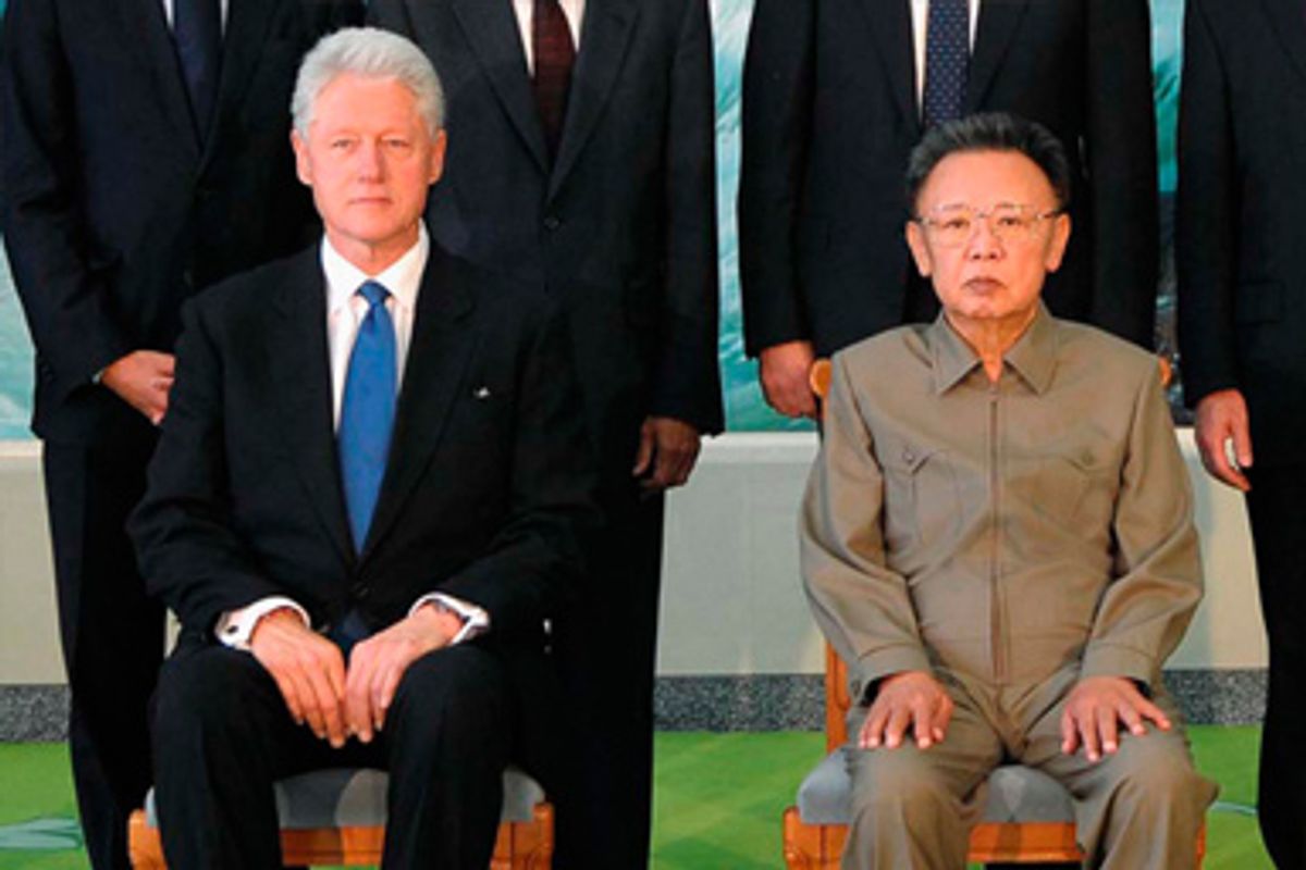 Former U.S. president Bill Clinton (seated L) and North Korea's leader Kim Jong-il (seated R) pose for a picture in Pyongyang in this photo released by North Korean official news agency KCNA August 4, 2009. 