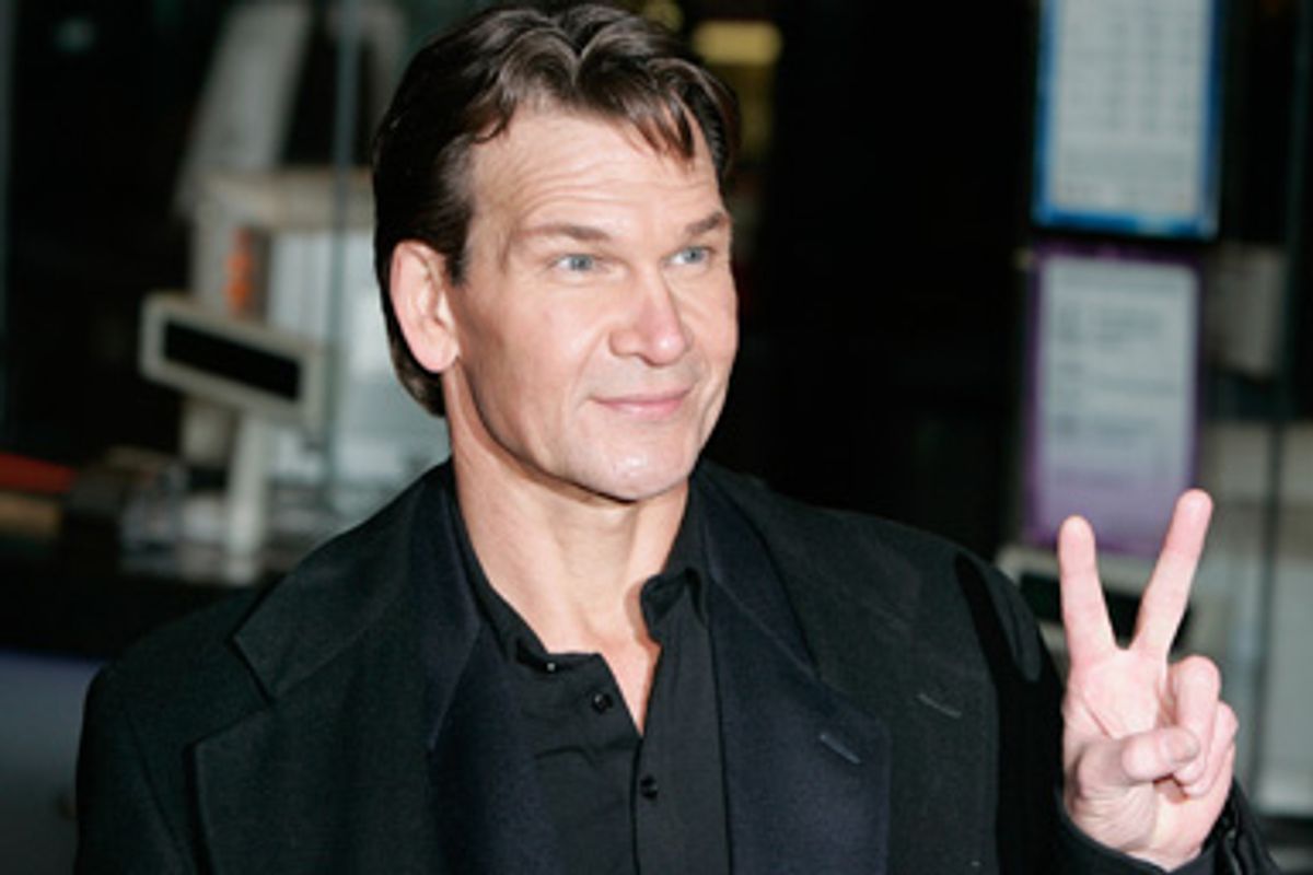 U.S. actor Patrick Swayze gestures to fans as he arrives at the world premiere of "Keeping Mum" at the Vue cinema in Leicester Square, London November 28, 2005. 