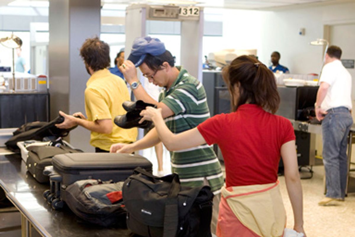 On the eve of the 8th anniversary of the September 11, 2001 attacks on the United States, travellers go through the passenger security screening facility at Dulles International Airport in Chantilly, Virginia, outside Washington, September 10, 2009.
