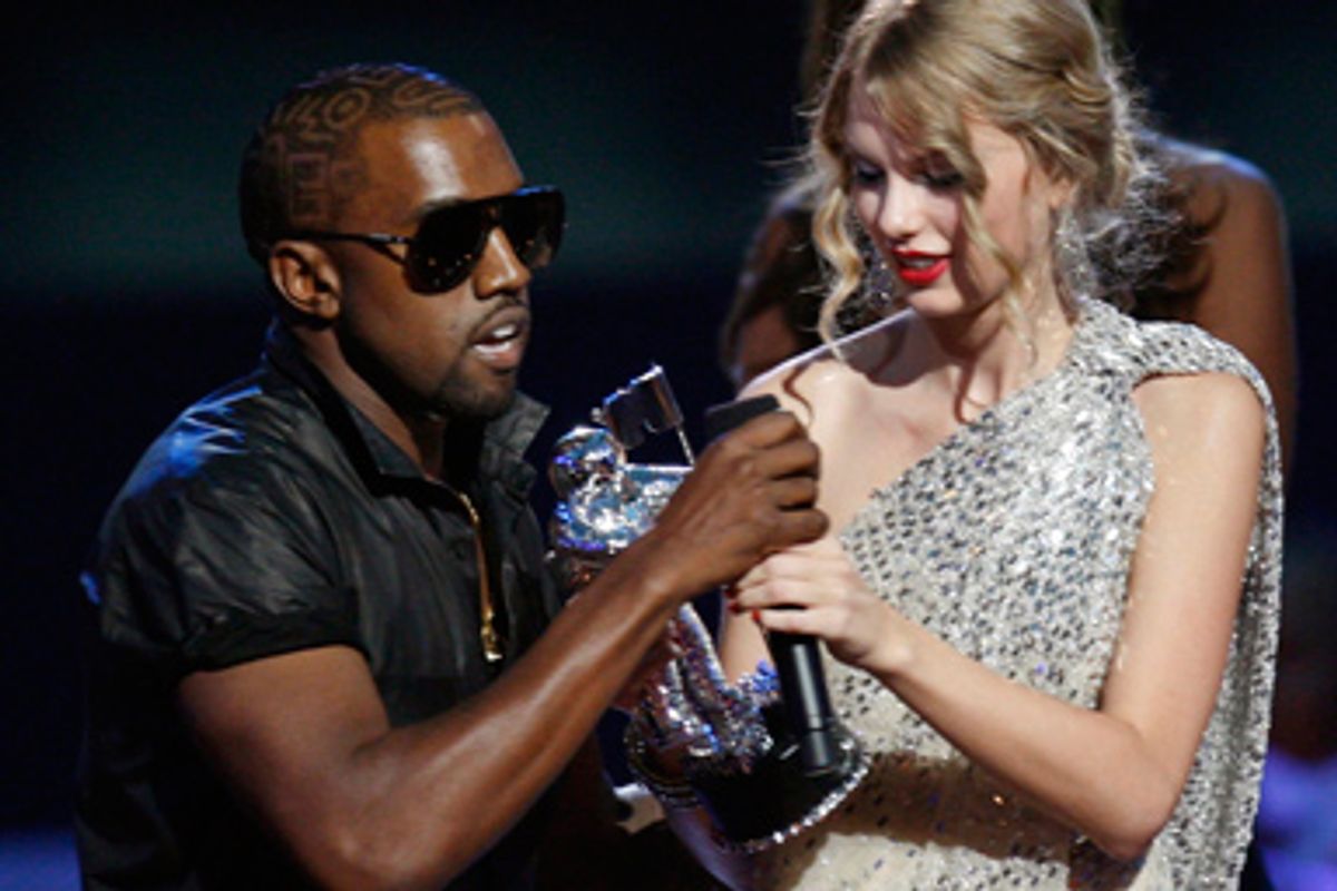 Kanye West takes the microphone from best female video winner Taylor Swift as he praises the video entry from Beyonce at the 2009 MTV Video Music Awards in New York, September 13, 2009.