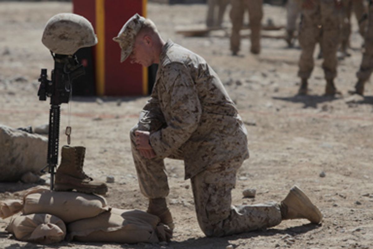 In this Thursday, Aug. 27, 2009 file photo, U.S. Marine Lt. Jake Godby pays his respects to Lance Cpl. Joshua Bernard during a memorial service at a forward operating base with Golf Company, 2nd Battalion, 3rd Marines, in Now Zad in the Helmand Province of Afghanistan.