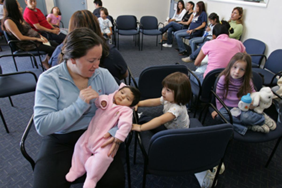 Mexican immigrant Alejandro Ruiz of Michoacan, Mexico, holds her two-month-old daughter, Antonia, in a waiting room at a hospital in Salinas, Calif., Thursday, Oct. 13, 2005.     