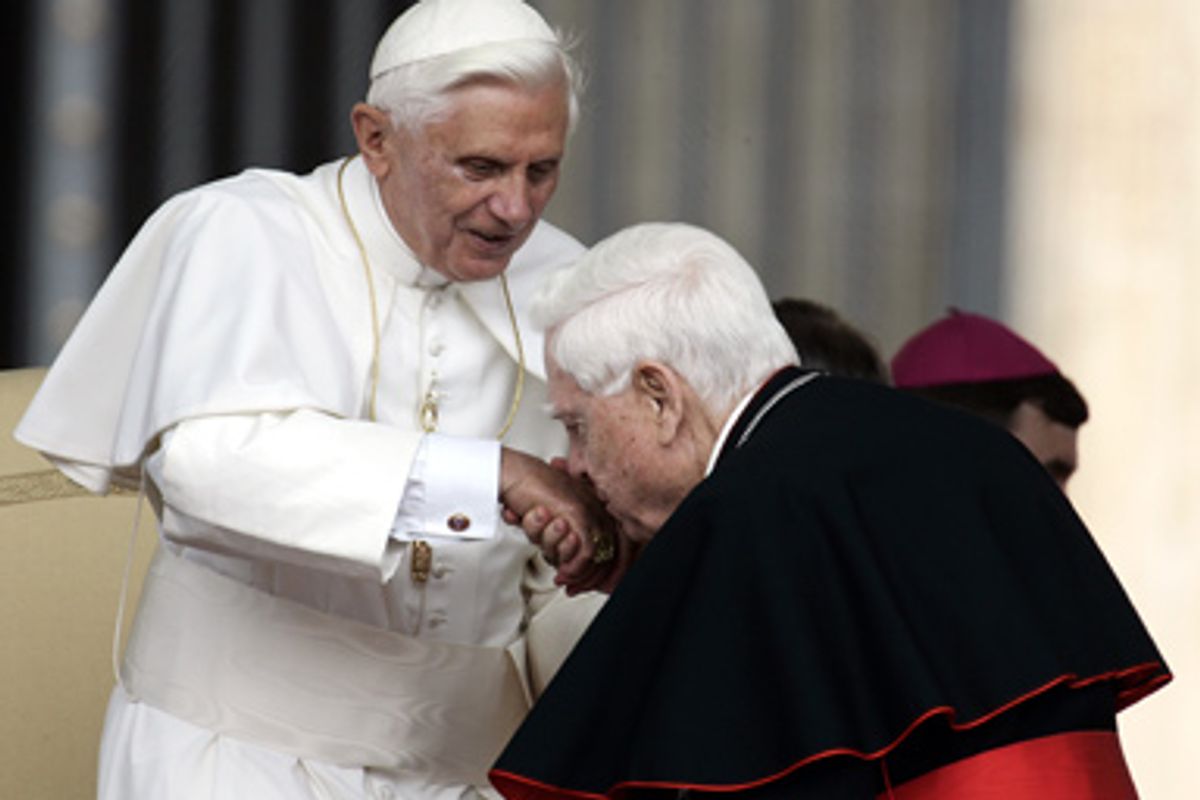 Pope Benedict XVI has his hand kissed by Cardinal Bernard Law during the weekly general audience in St. Peter's Square at the Vatican, Wednesday June 7, 2006.       