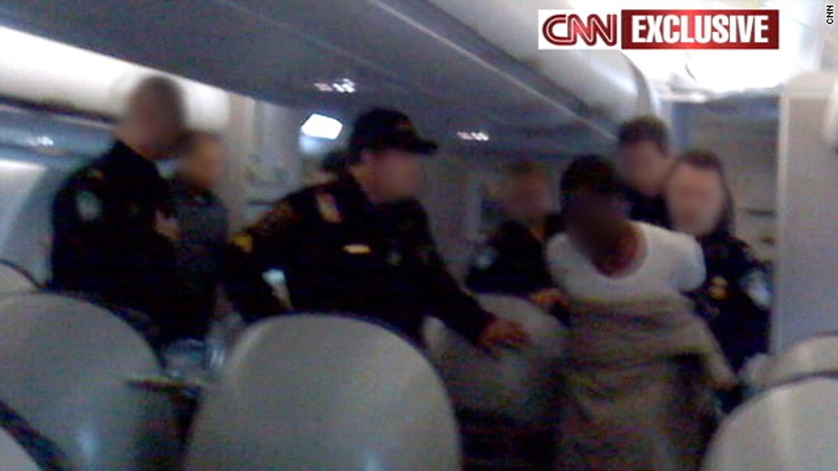 23-year-old Umar Farouk Abdulmutallab being taken into custody on Flight 253. (Photo courtesy CNN)
