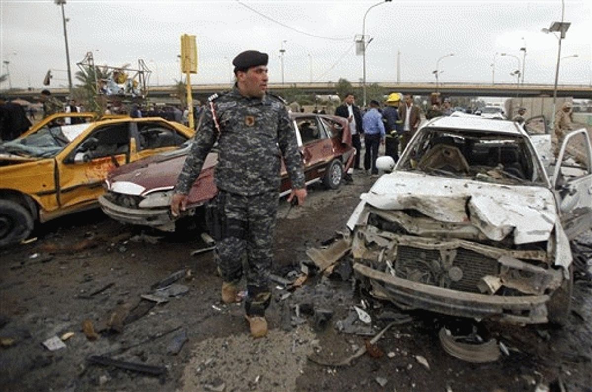 An Iraqi policeman inspects the site of a bomb attack near the Labor Ministry building in Baghdad, Iraq, Tuesday. 