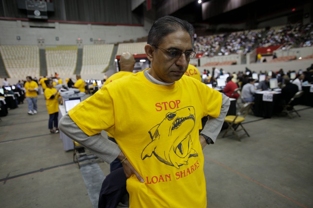 Volunteer Rajesh Kumar wears a motivational t-shirt at the Cow Palace in Daly City, Calif., Friday, Oct. 16, 2009. Thousands of home owners turned out to an event sponsored by NACA, A Boston-based non-profit helping people to re-structure high risk loans. (AP Photo/Marcio Jose Sanchez) (Associated Press)