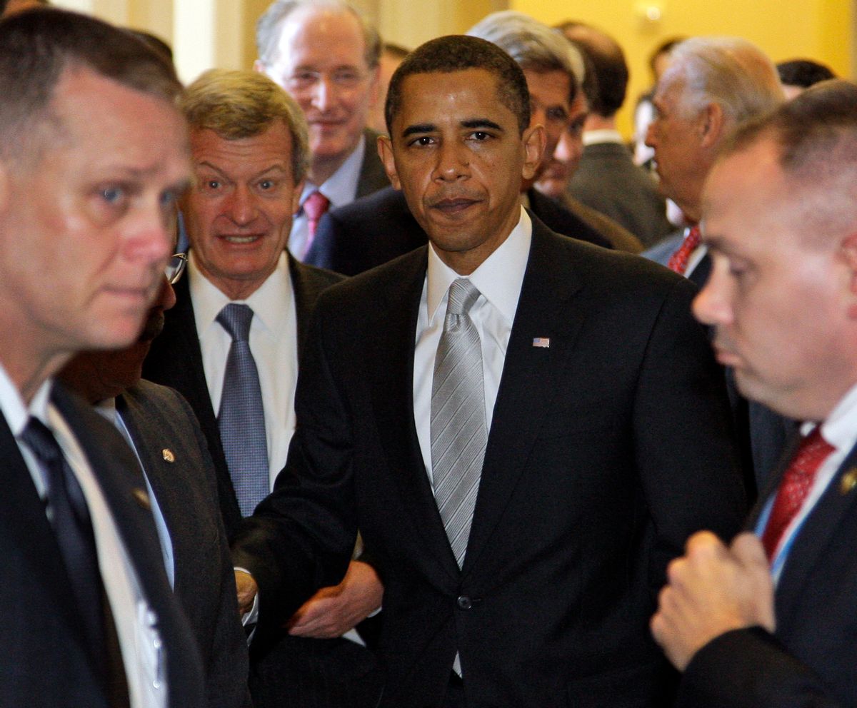 President Barack Obama, center, with Sen. Max Baucus, D-Mont., second from left, walks out of the Senate Democratic caucus on Capitol Hill in Washington Sunday, Dec. 6, 2009. The Senate is meeting in a rare Sunday session to debate health care overhaul.(AP Photo/Alex Brandon) (Associated Press)
