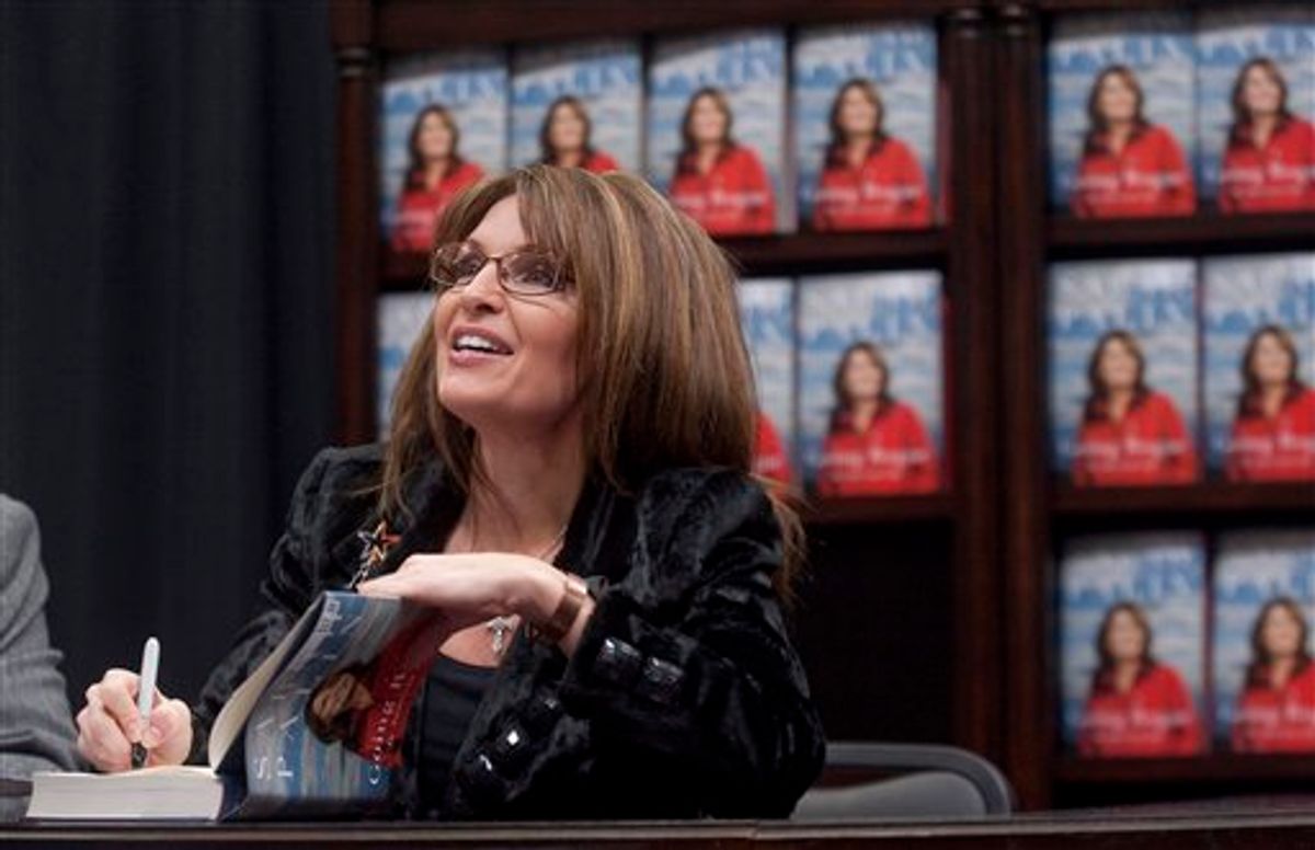 Former Alaska Gov. Sarah Palin signs a copy of "Going Rogue" during a book signing event at a Sam's Club on Thursday, Dec. 3, 2009, in Fayetteville, Ark. (AP Photo/Beth Hall) (AP)