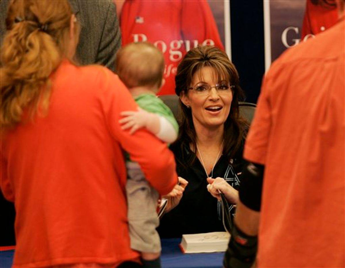 Former Alaska Gov. Sarah Palin signs a copy her her autobiography, "Going Rogue", at the North Post Exchange at Fort Bragg, N.C., Monday, Nov. 23, 2009. (AP Photo/Jim R. Bounds) (Associated Press)