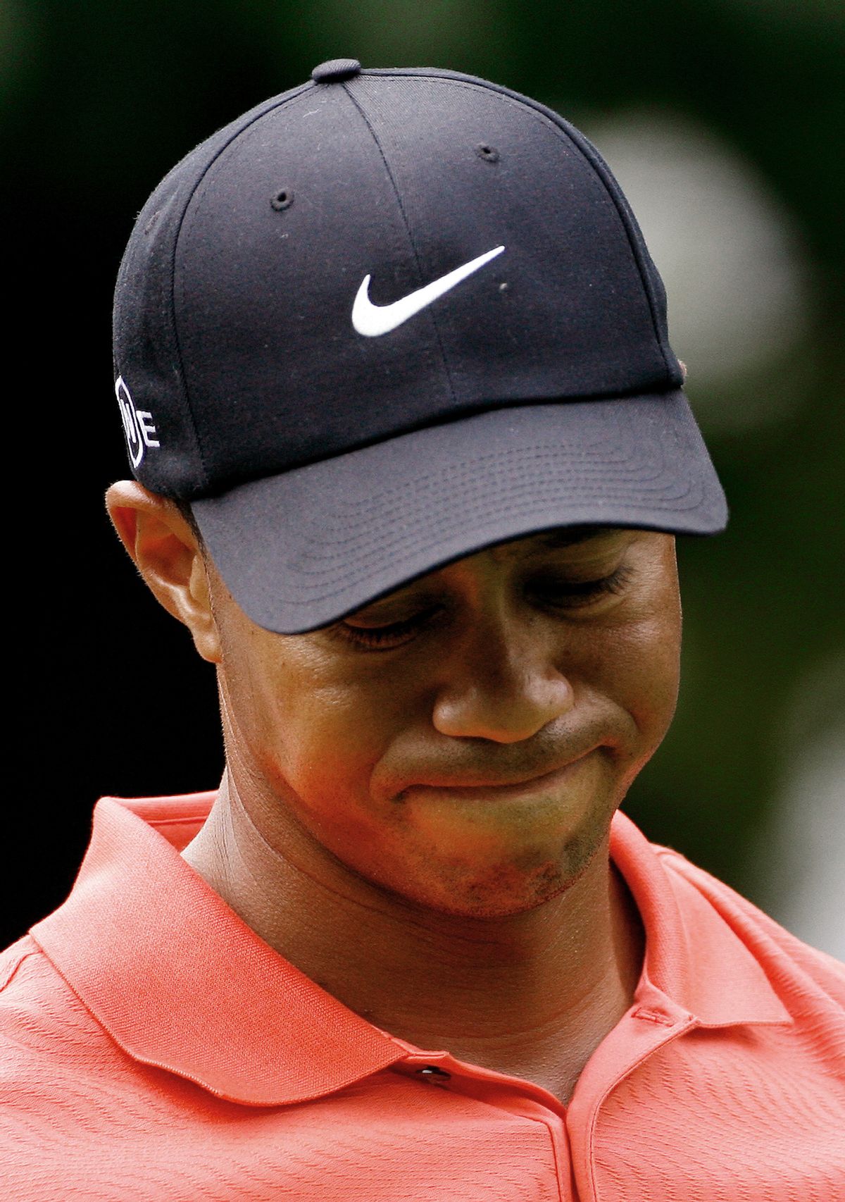 U.S. golfer Tiger Woods reacts after teeing off at the 14th hole during the World Match Play Championship at the Wentworth Club in Virginia Water, southeast England, September 14, 2006. World number one Woods, who arrived at Wentworth on the back of a remarkable run of five successive tournament wins, wielded a cold putter all day as he lost 4 &amp; 3 to fellow American Shaun Micheel. REUTERS/Kieran Doherty  (BRITAIN) (Reuters)