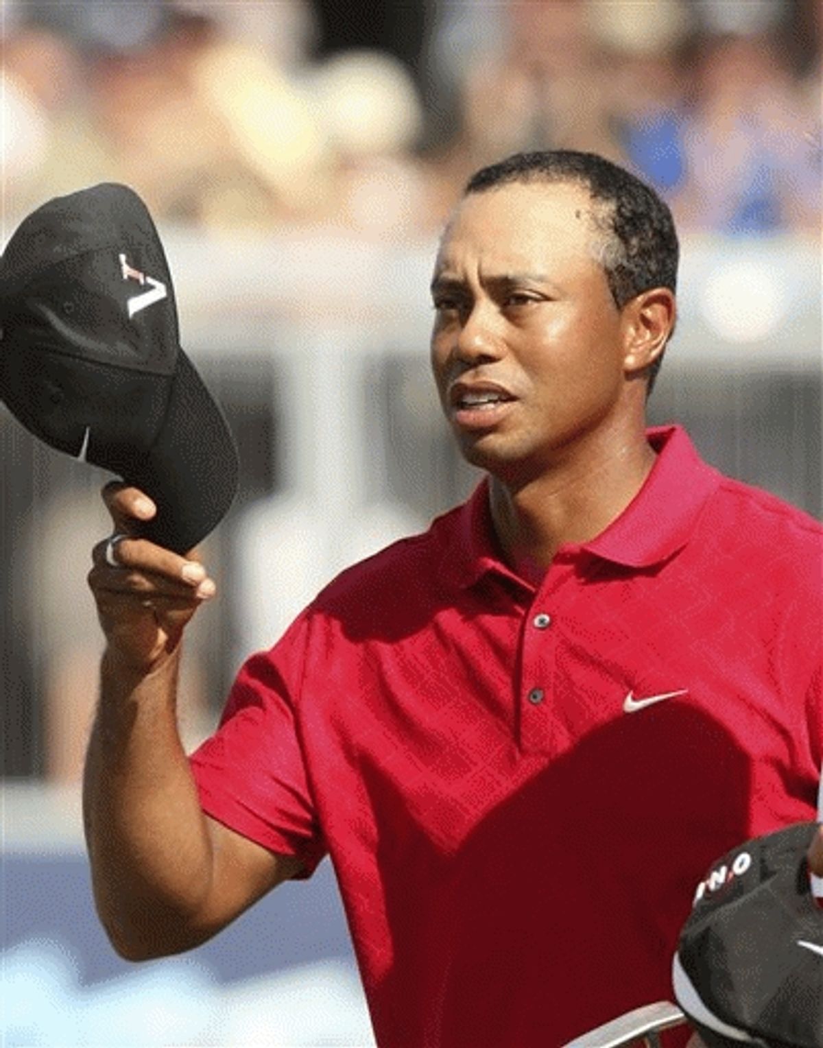 In this Nov. 15, 2009 file photo, Tiger Woods, tips his cap to the crowd after finishing his final hole in Melbourne, Australia, during the Australian Masters golf tournament.  (AP Photo/Rob Griffith, File)