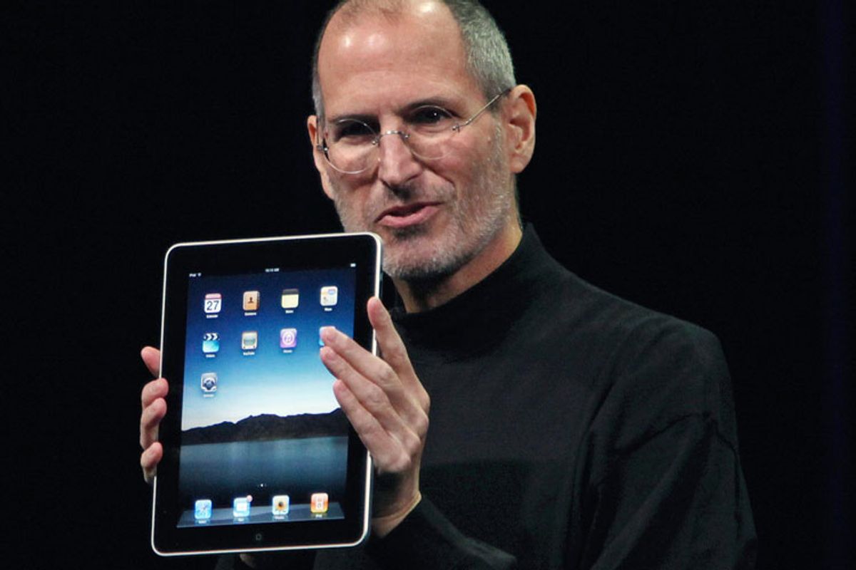 Apple CEO Steve Jobs holds the new iPad during the launch of the new tablet computing device in San Francisco Wednesday.          