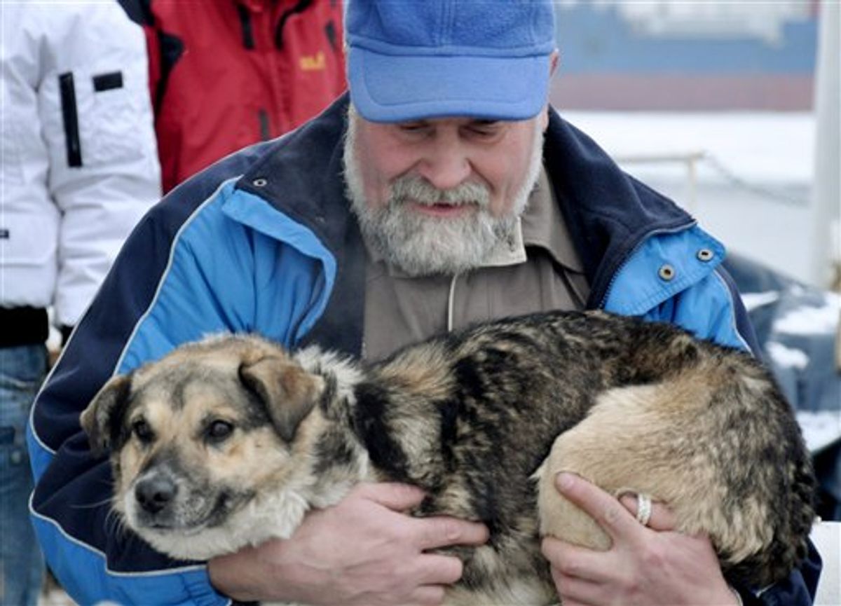 In this photo taken Tuesday, Jan. 26, 2010 and made available Thursday, Jan 28, 2010 Adam Buczynski carries a dog found floating cold and alone on an ice floe 15 miles off the Polish Baltic Sea coast in Gdynia,  Poland. Buczynski, a sailor from the ship "Baltic"  pulled out the dog from the ice floe. (AP Photo/Maciej Czoska)  ** POLAND OUT **  (AP)