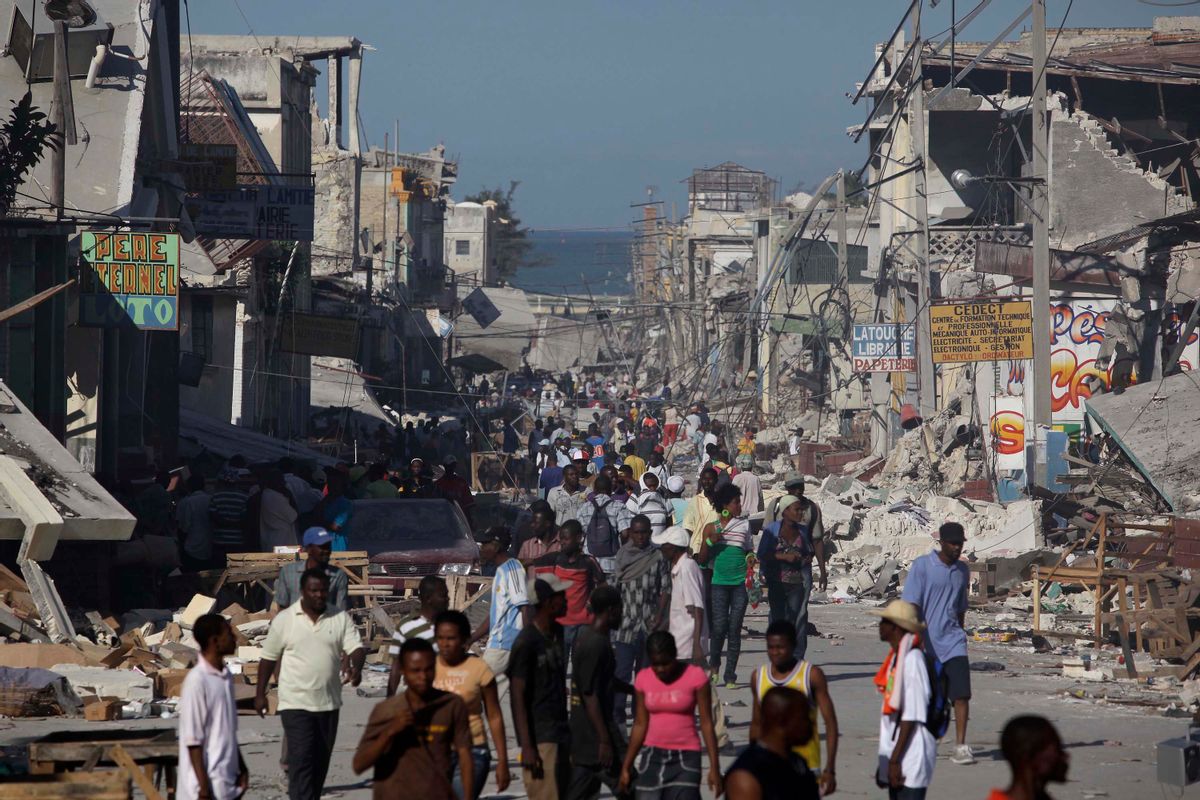 Displaced Haitians walk the streets amidst collapsed buildings and rubble in downtown Port Au Prince Thursday, Jan. 14, 2010, in Port au Prince, Haiti.  (AP/Julie Jacobson)