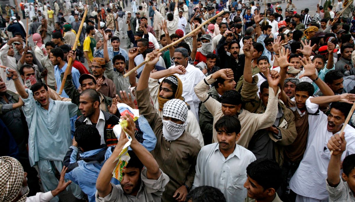 Men shout slogans during a protest rally on the streets of Karachi January 11, 2010. Several thousands protested against paramilitary and police search operation after a spate of violence in the city. They accused forces of targeting innocent people during the raid in which a paramilitary spokesman said about a dozen suspects were detained.  REUTERS/Athar Hussain (PAKISTAN - Tags: POLITICS CIVIL UNREST) (Reuters)