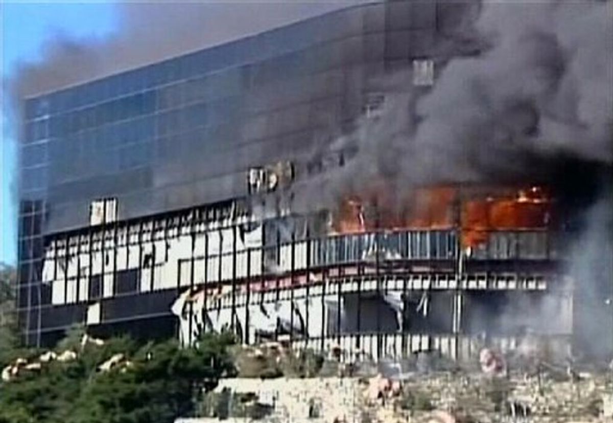 In this image made from KVUE-TV video, smoke billows from a seven-story building after a small private plane crashed into the building  in Austin, Texas on Thursday Feb. 18, 2010. (AP Photo/KVUE-TV) MANDATORY CREDIT  (AP)