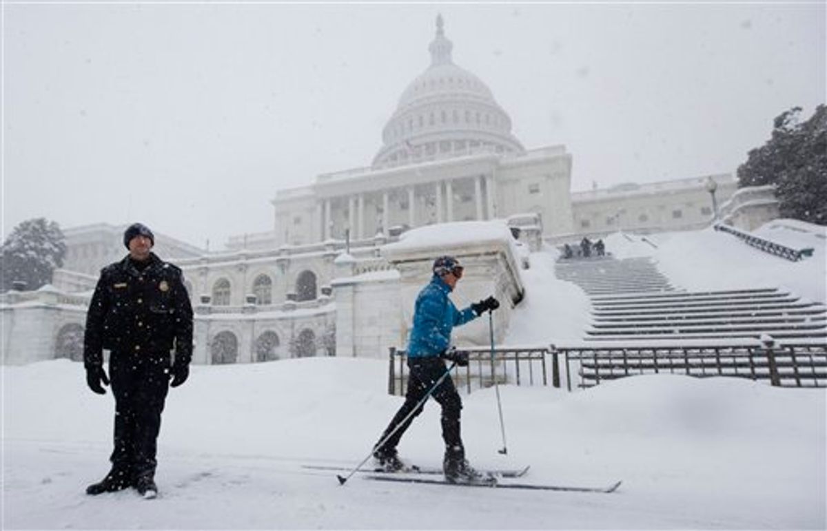 Emily Tibbott skis past U.S. Capitol Police Officer Sean Whitehead, standing guard on Capitol Hill in Washington, Wednesday, Feb. 10, 2010, as more snow fell in the Washington area.  (AP Photo/Manuel Balce Ceneta)   (AP)
