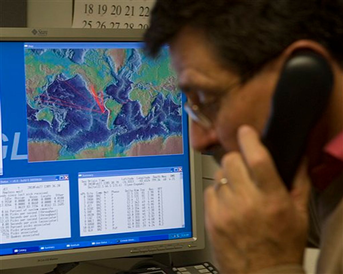 With a computer graphic showing the possible path of tsunami waves from an earthquake in Chile, Dr. Charles McCreery speaks on the phone at the Pacific Tsunami Warning Center, Saturday, Feb. 27, 2010 in Ewa Beach, Hawaii.  The State of Hawaii is under a tsunami warning after an 8.8 magnitude earthquake rattled Chile today.  (AP Photo/Marco Garcia)   (AP)