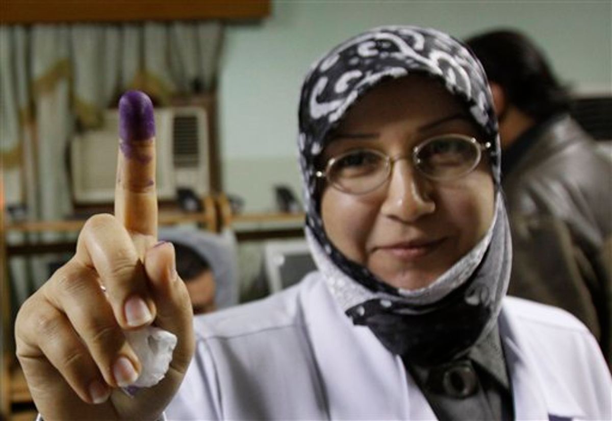 Dr. Raya Jabur displays her inked finger after casting her vote at Al-Fayha hospital in Basra, Iraq, Thursday, March 4, 2010. Early voting in Iraq for detainees, hospital patients and military and security personnel is taking place Thursday, ahead of the parliamentary elections on Sunday, March 7, 2010. (AP Photo/Nabil al-Jurani) (AP)