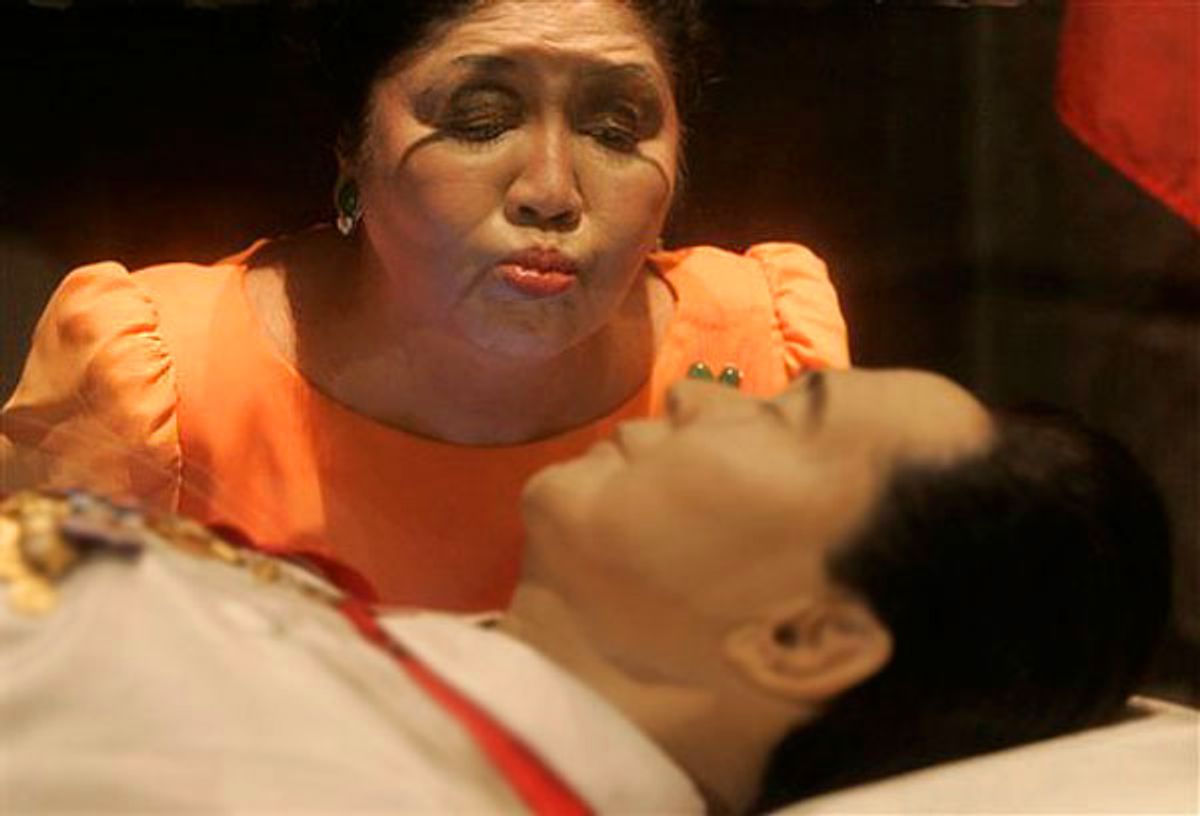 Imelda Marcos kisses the glass coffin of her husband, the late Ferdinand Marcos, before she starts her motorcade campaign in Ilocos Norte, northern Philippines, March 26, 2010.